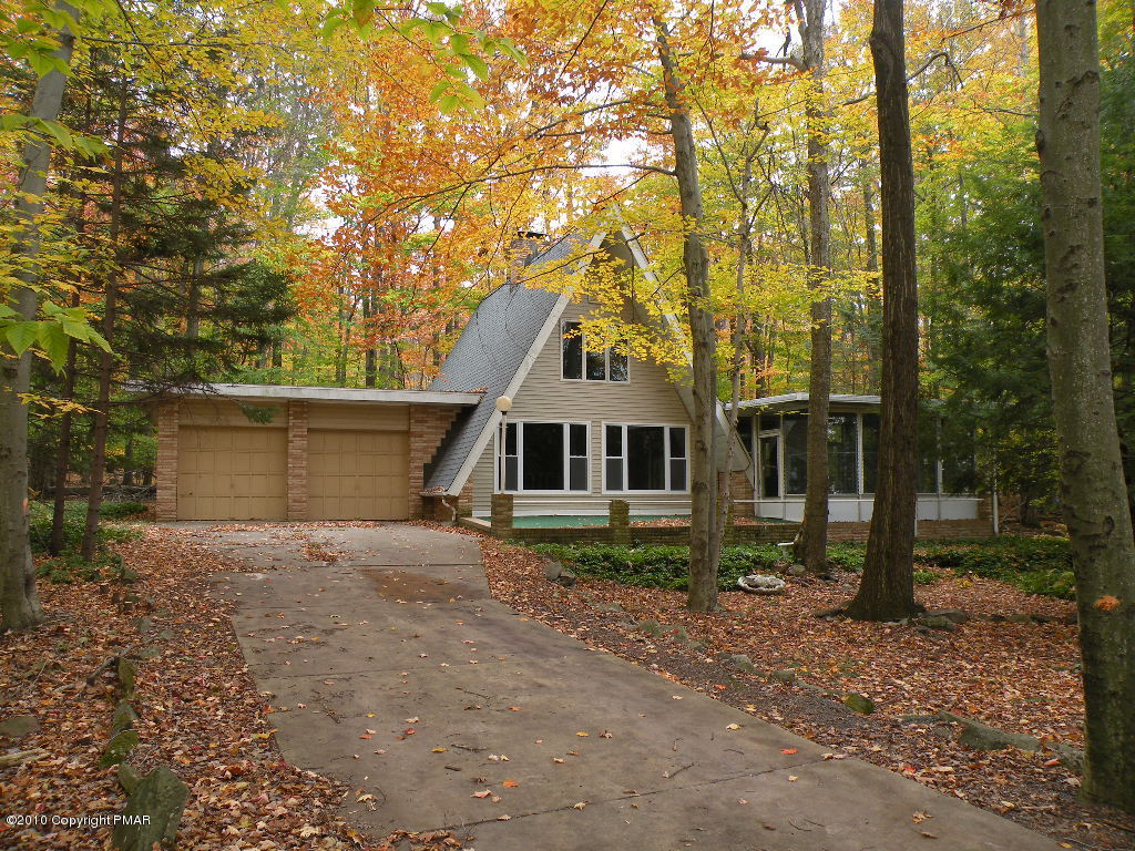 715 Deer Run Road Pocono Lake, PA 18347 - Photo 1 of 20 a house that has a tree in front of it