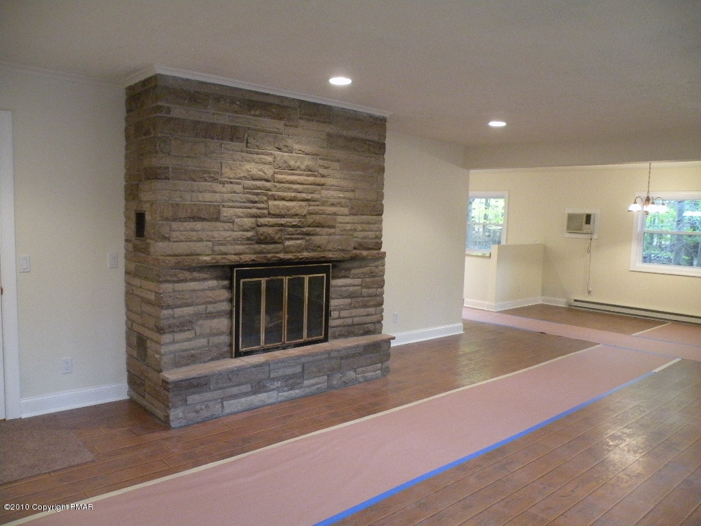 715 Deer Run Road Pocono Lake, PA 18347 - Photo 2 of 20 a view of an empty room with window and wooden floor