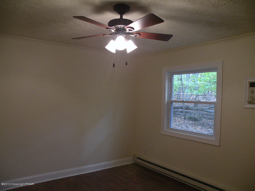 715 Deer Run Road Pocono Lake, PA 18347 - Photo 9 of 20 an empty room with a window and a fan