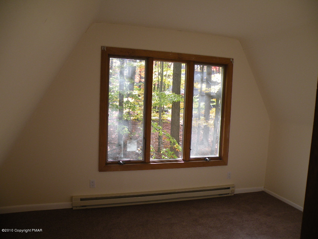 715 Deer Run Road Pocono Lake, PA 18347 - Photo 10 of 20 wooden floor and window in an empty room