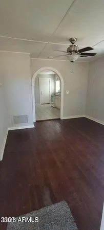 a view of empty room with wooden floor