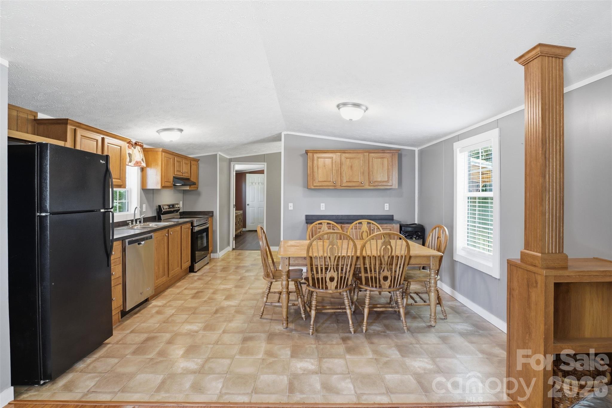 4406 Lucy Short Cut Road Marshville, NC 28103 - Photo 10 of 30 a large kitchen with a refrigerator and wooden cabinets