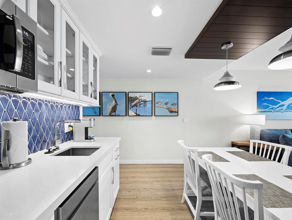 210 Sands Point Road, Unit 2405 Longboat Key, FL 34228 - Photo 11 of 36 a kitchen that has a sink and a stove