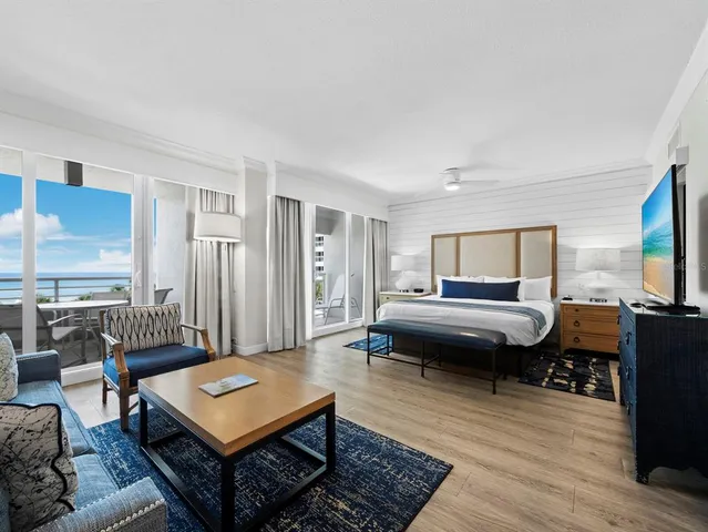 a bedroom with furniture and a flat screen tv