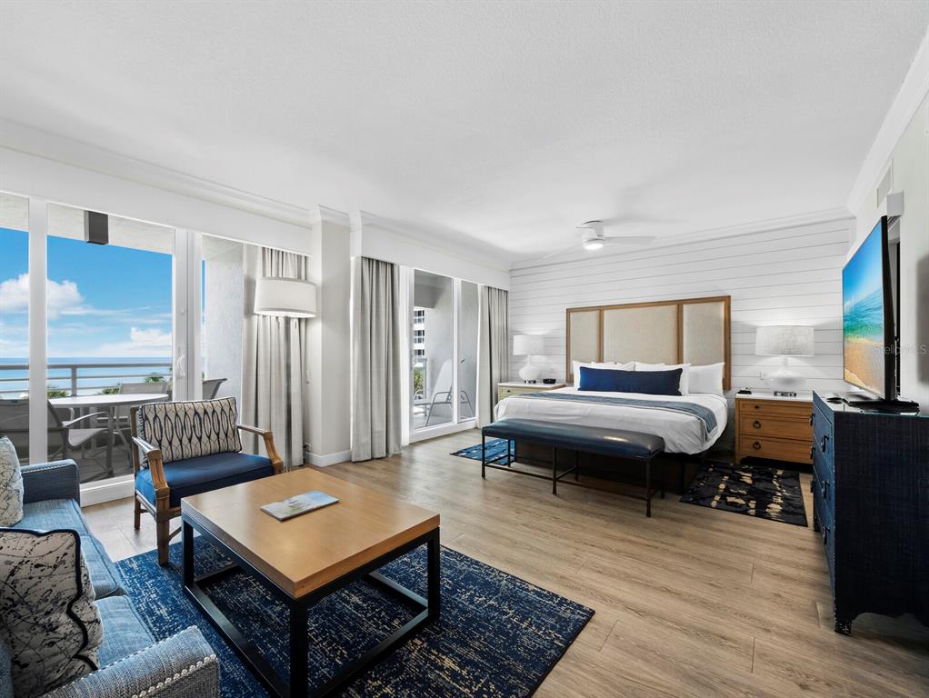 210 Sands Point Road, Unit 2405 Longboat Key, FL 34228 - Photo 13 of 36 a living room with furniture and a flat screen tv