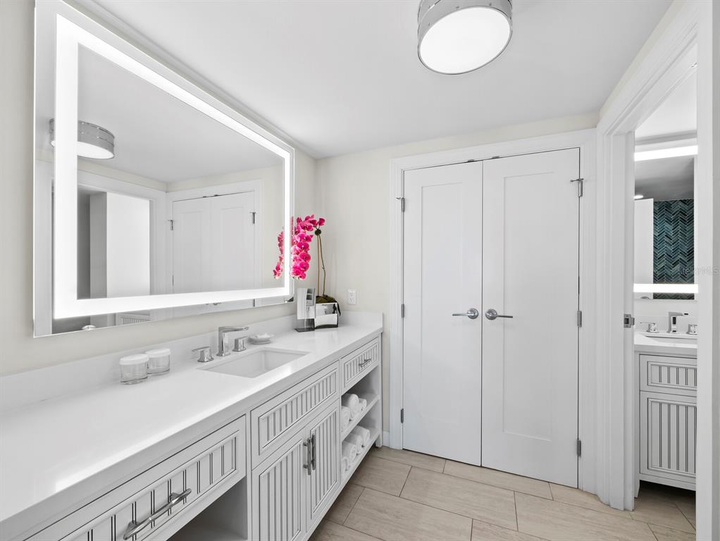 210 Sands Point Road, Unit 2405 Longboat Key, FL 34228 - Photo 16 of 36 a bathroom with a double vanity sink and a mirror