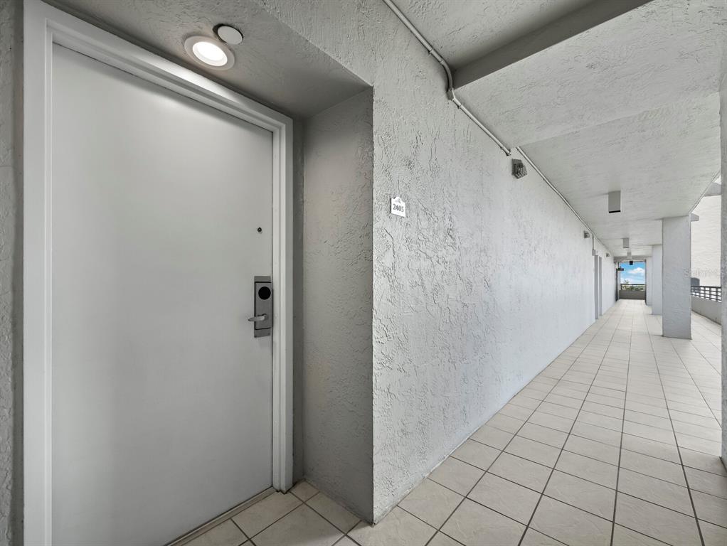 210 Sands Point Road, Unit 2405 Longboat Key, FL 34228 - Photo 4 of 36 a view of a hallway to closet and a bathroom
