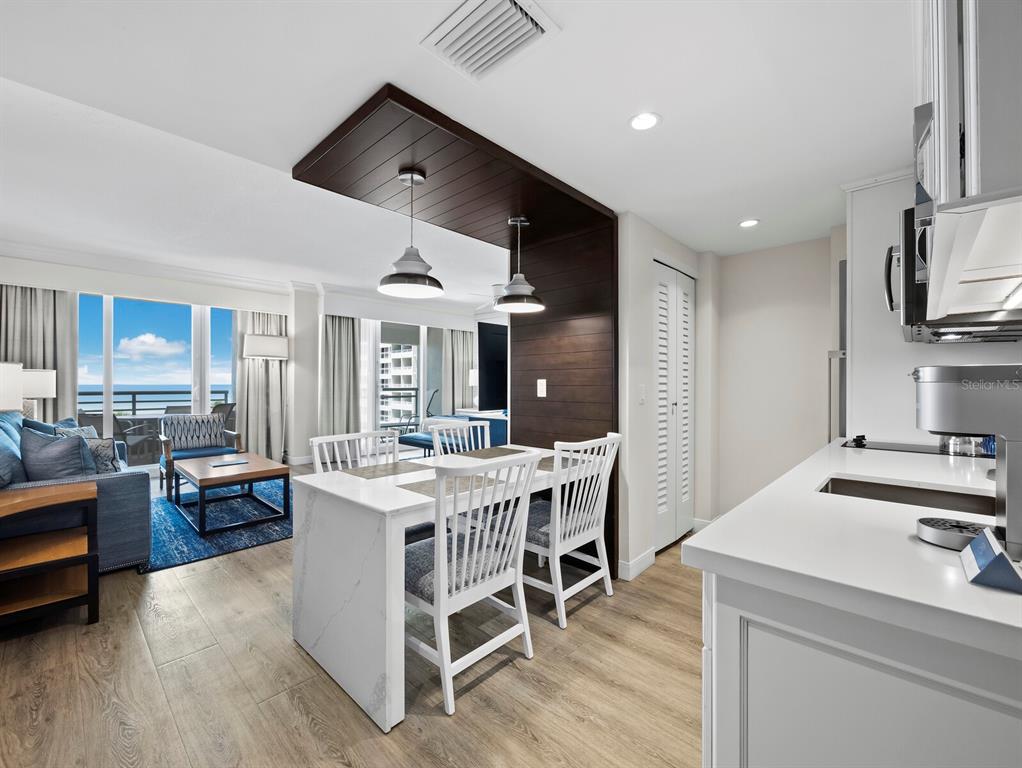 210 Sands Point Road, Unit 2405 Longboat Key, FL 34228 - Photo 6 of 36 a view of a dining room with furniture window and wooden floor