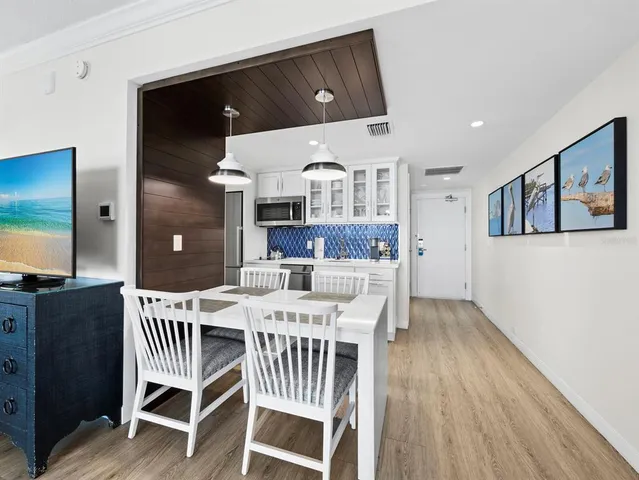 a kitchen with a stove and a white cabinets