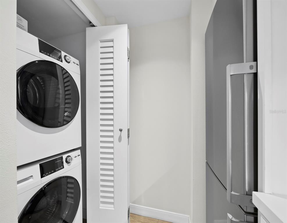 210 Sands Point Road, Unit 2405 Longboat Key, FL 34228 - Photo 10 of 36 a utility room with dryer and washer