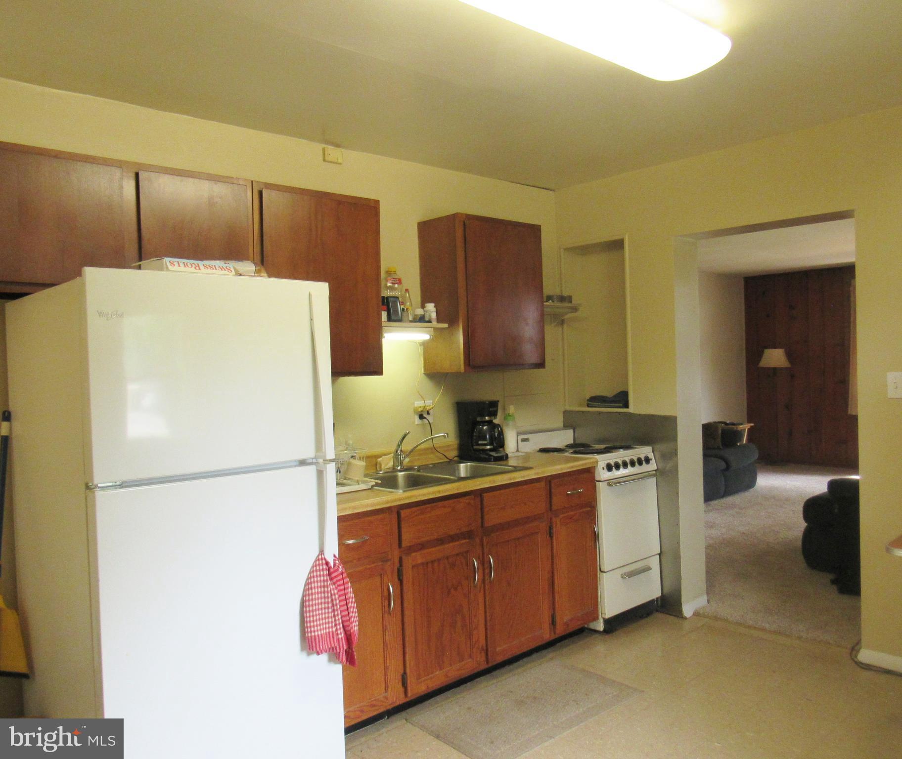 15619 Livingston Road Accokeek, MD 20607 - Photo 4 of 18 a kitchen with a refrigerator a stove top oven and cabinets