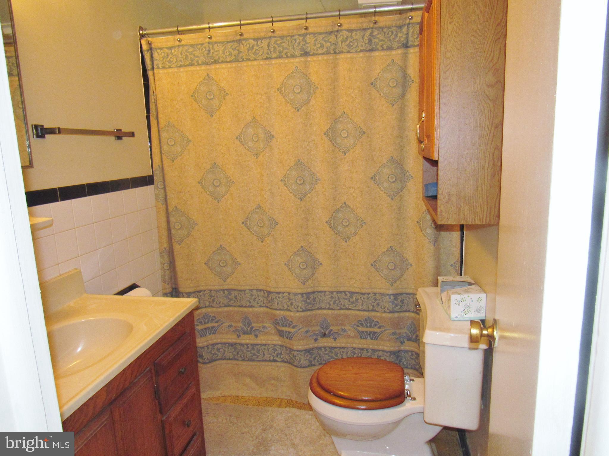 15619 Livingston Road Accokeek, MD 20607 - Photo 7 of 18 a bathroom with a granite countertop sink toilet and shower