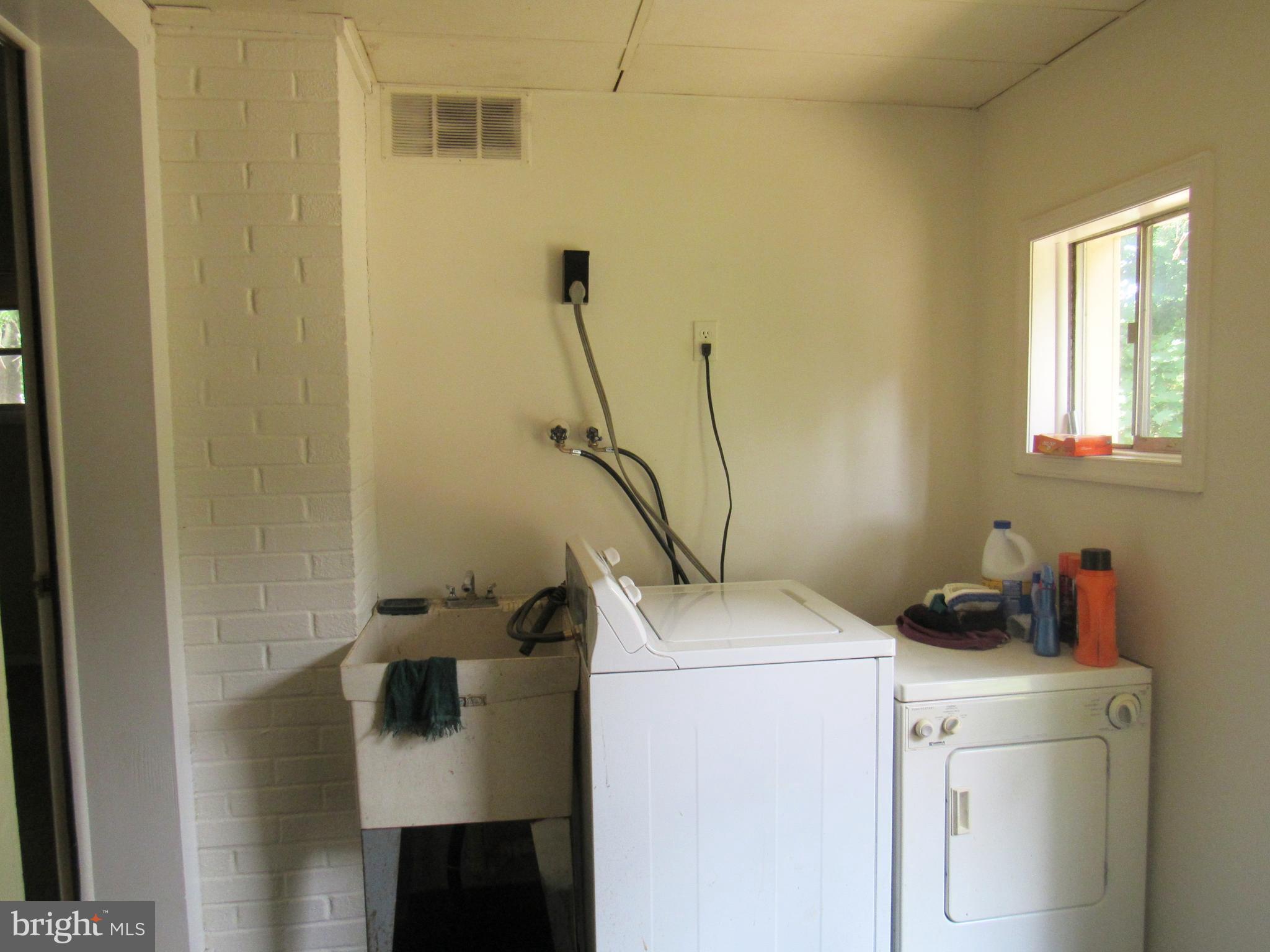 15619 Livingston Road Accokeek, MD 20607 - Photo 8 of 18 a view of storage and utility room with a washer and dryer