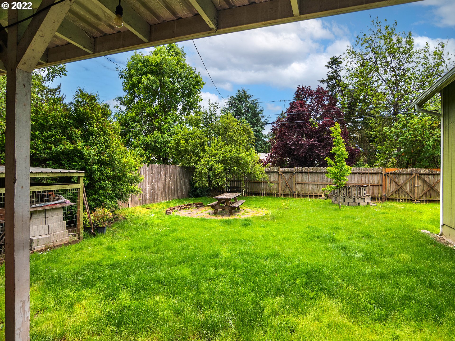 1239 D Street Springfield, OR 97477 - Photo 28 of 32 a view of a backyard with wooden fence and a bench