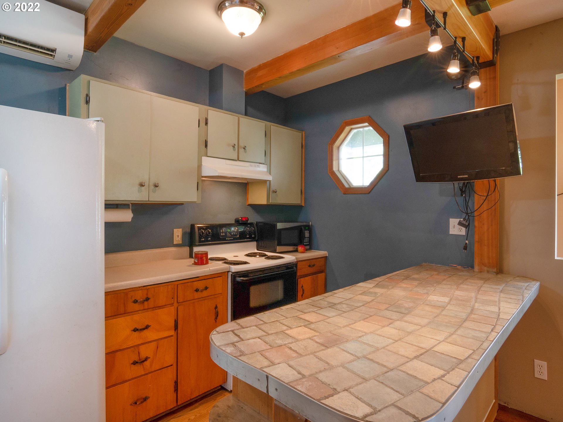 1239 D Street Springfield, OR 97477 - Photo 10 of 32 a kitchen with a stove a sink and a refrigerator