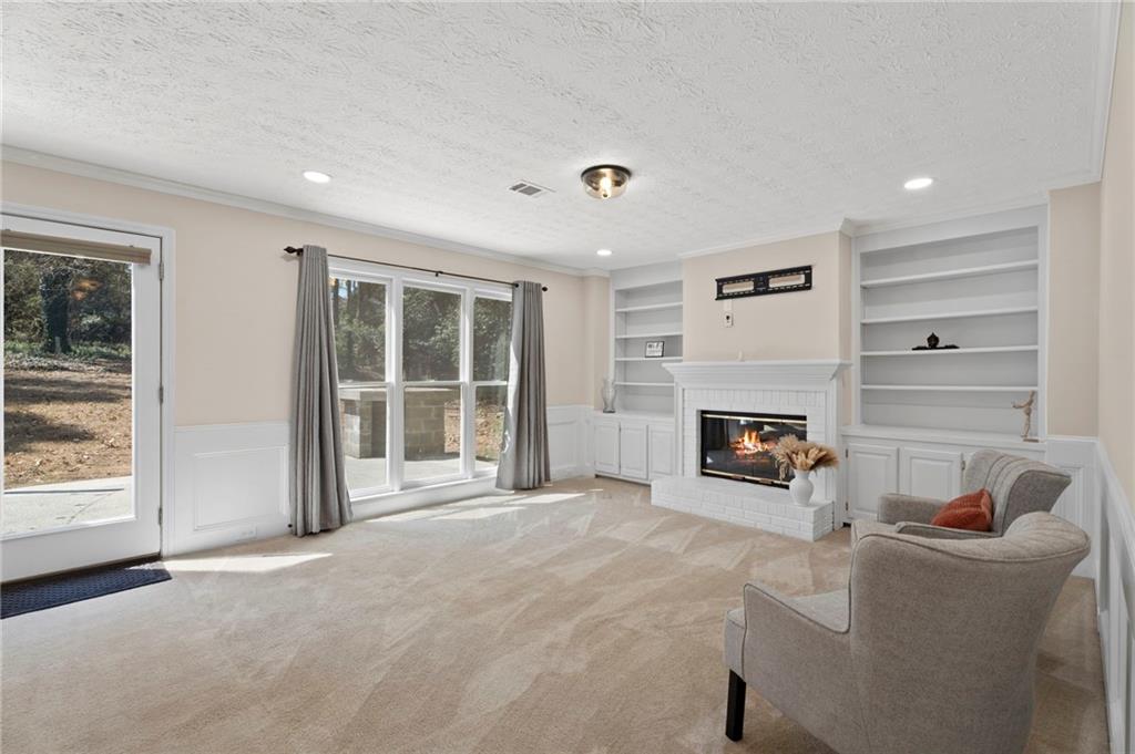 1381 Gateswalk Path Lawrenceville, GA 30045 - Photo 19 of 45 a living room with furniture and a fireplace