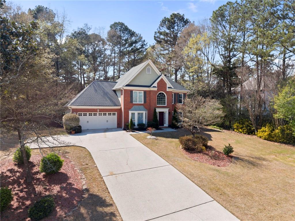 1381 Gateswalk Path Lawrenceville, GA 30045 - Photo 2 of 45 a front view of a house with yard and trees in the background