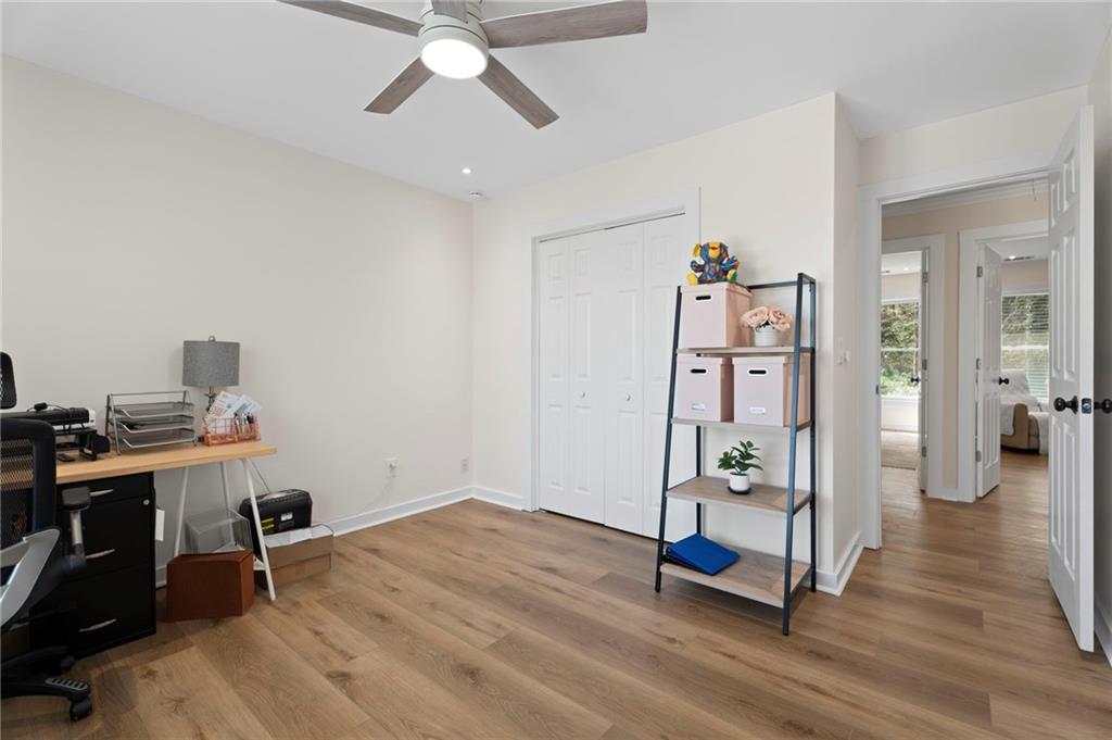 1381 Gateswalk Path Lawrenceville, GA 30045 - Photo 25 of 45 a view of a workspace with wooden floor and a ceiling fan