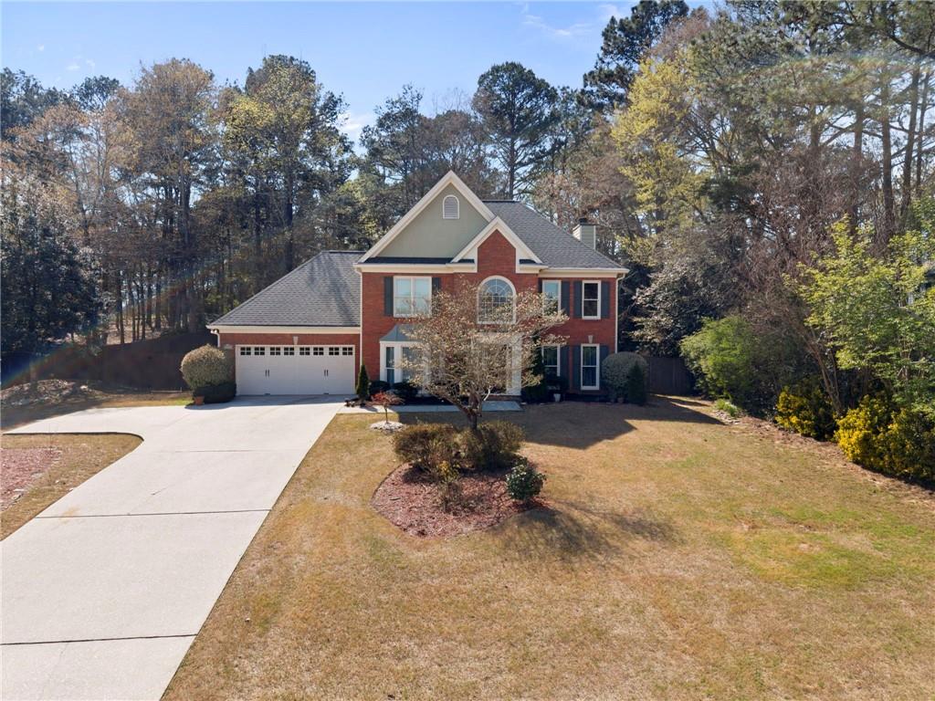 1381 Gateswalk Path Lawrenceville, GA 30045 - Photo 3 of 45 a front view of a house with a yard and trees