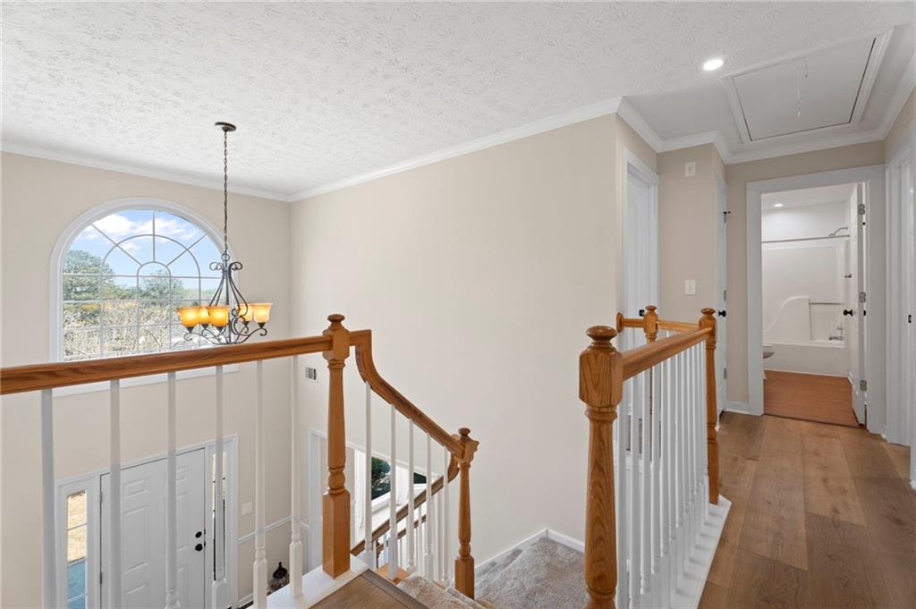 1381 Gateswalk Path Lawrenceville, GA 30045 - Photo 31 of 45 a view of a hallway with wooden floor and staircase