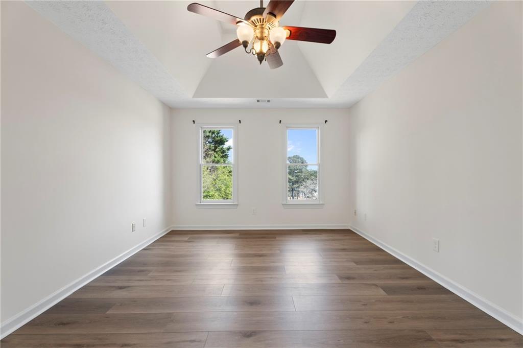 1381 Gateswalk Path Lawrenceville, GA 30045 - Photo 33 of 45 a view of room with window ceiling fan and wooden floor