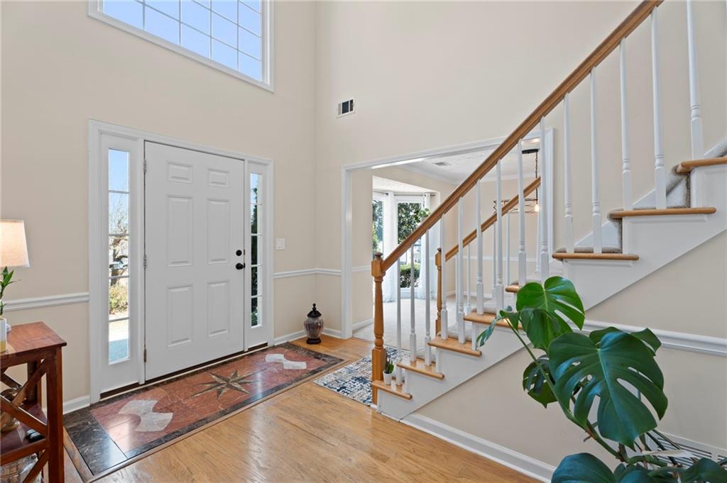 1381 Gateswalk Path Lawrenceville, GA 30045 - Photo 5 of 45 a view of entryway with wooden floor and stairs