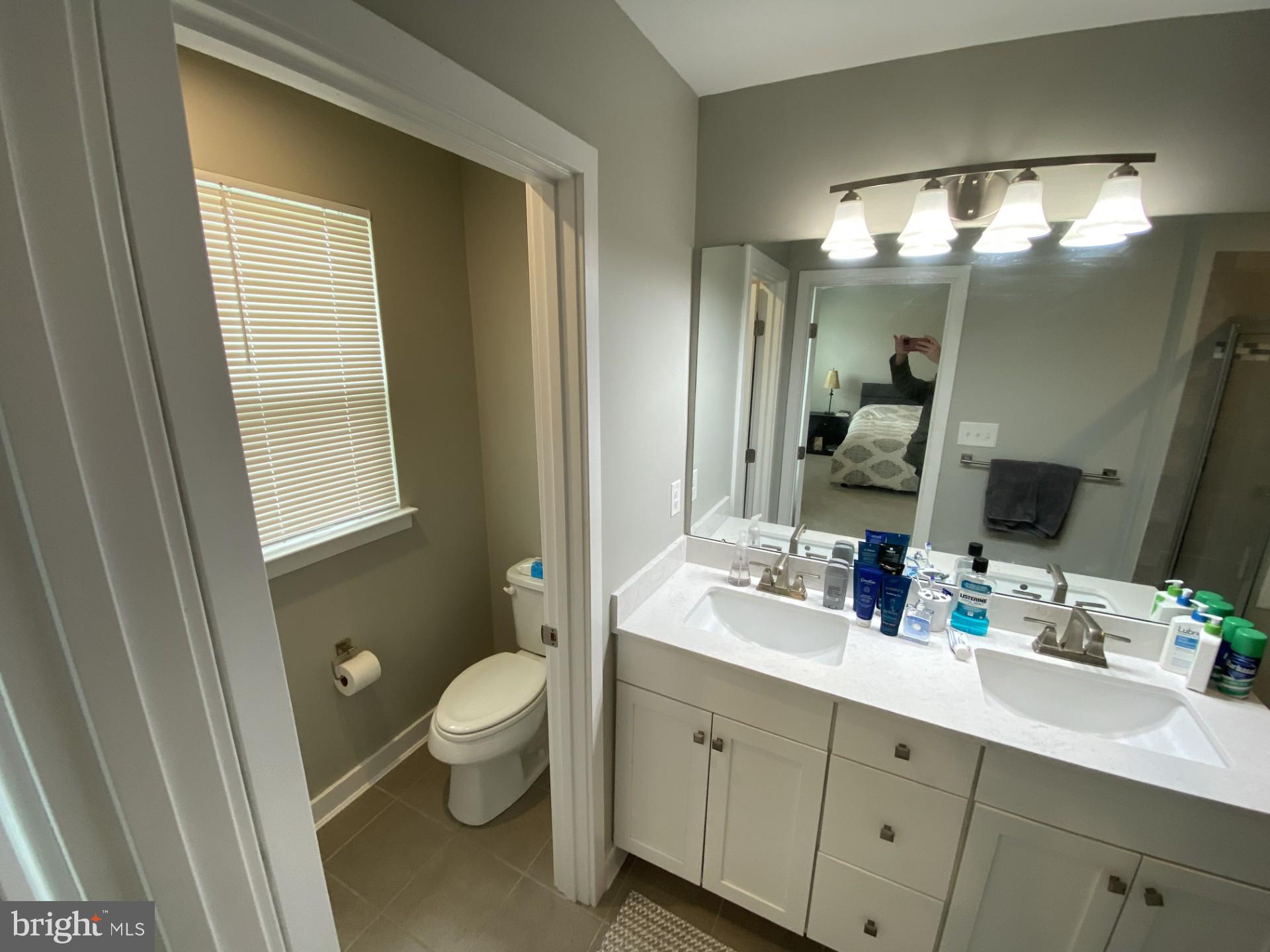 1214 Benjamin Drive Kennett Square, PA 19348 - Photo 12 of 34 a bathroom with a double vanity sink toilet and mirror
