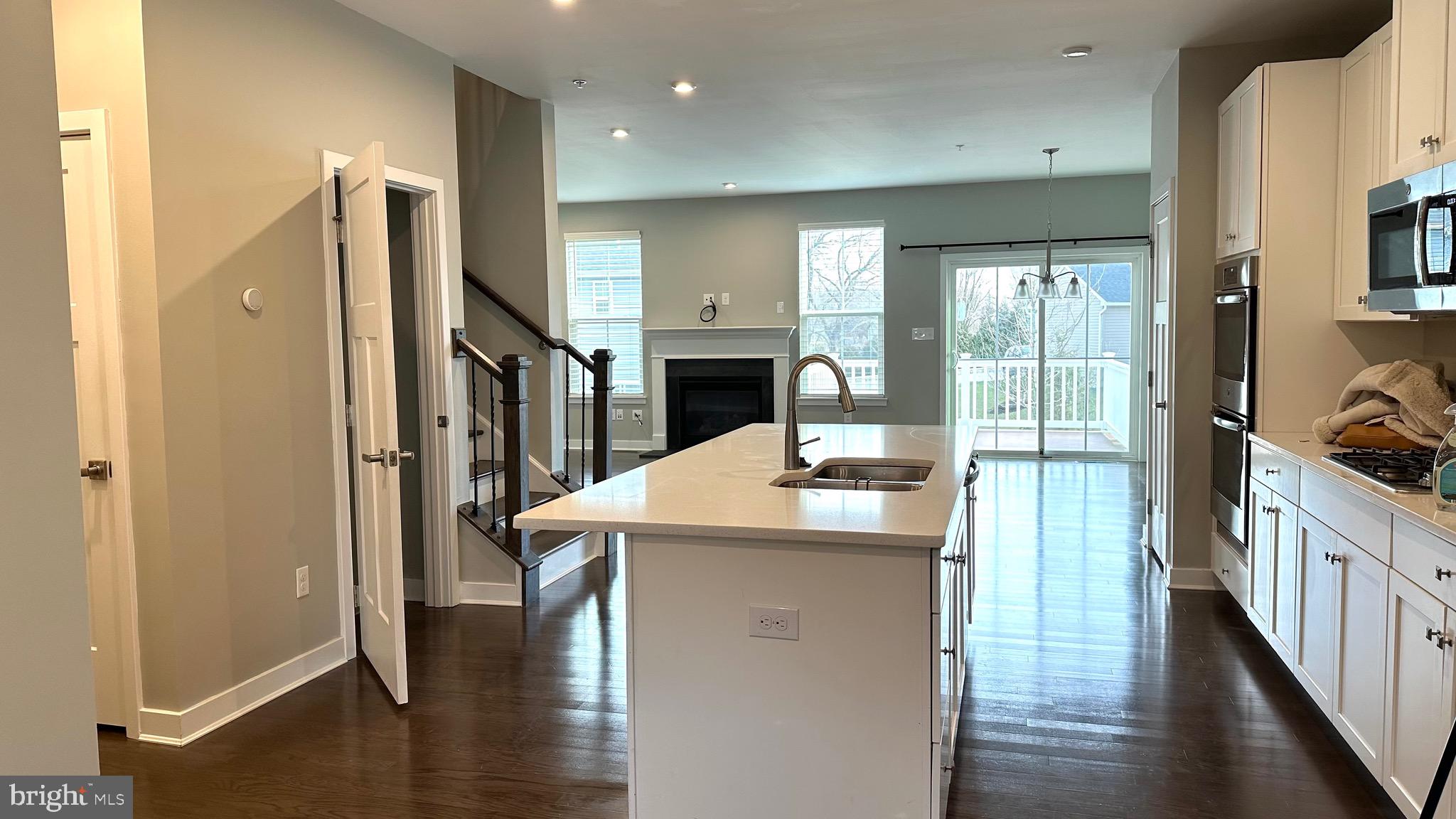 1214 Benjamin Drive Kennett Square, PA 19348 - Photo 2 of 34 a kitchen with stainless steel appliances kitchen island granite countertop a refrigerator a stove and a cabinets with wooden floor
