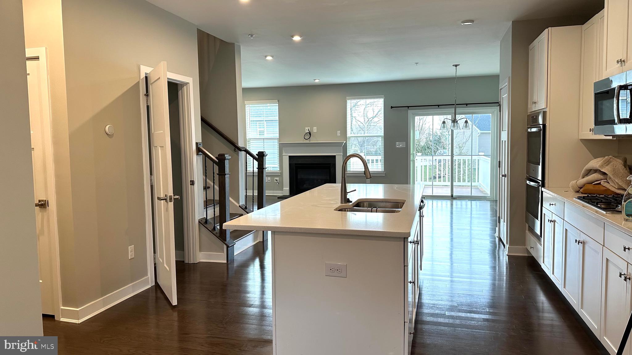 1214 Benjamin Drive Kennett Square, PA 19348 - Photo 34 of 34 a kitchen with stainless steel appliances kitchen island granite countertop a refrigerator a stove and a cabinets with wooden floor