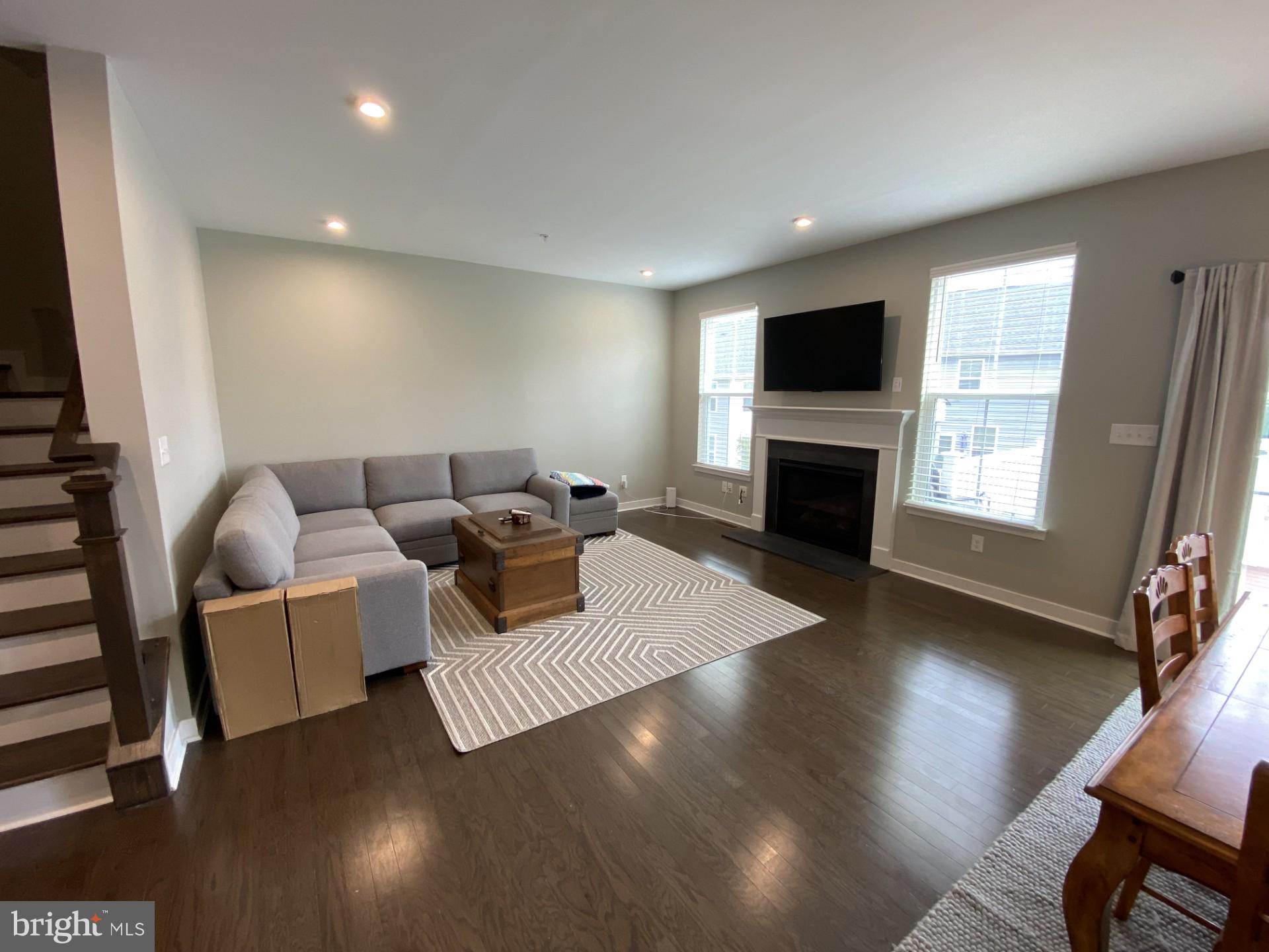 1214 Benjamin Drive Kennett Square, PA 19348 - Photo 8 of 34 a living room with furniture flat screen tv and a fireplace
