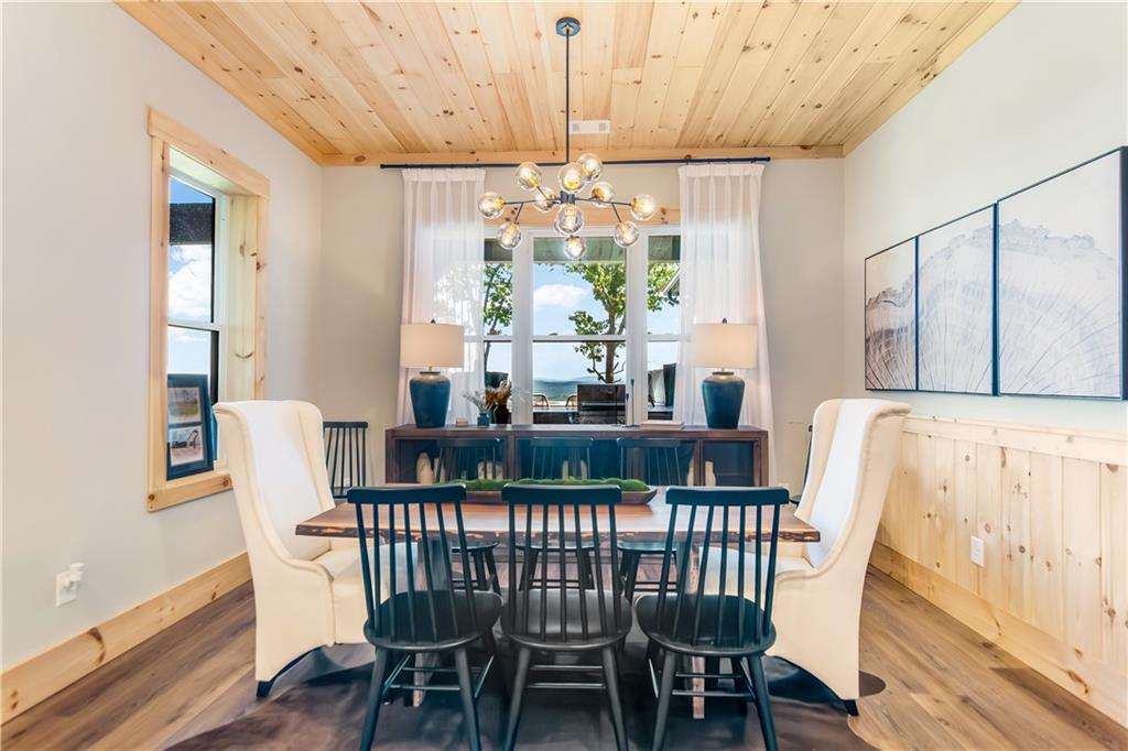1272 Foxhound Trail Northeast Ranger, GA 30734 - Photo 54 of 69 a view of a dining room with furniture a chandelier and wooden floor