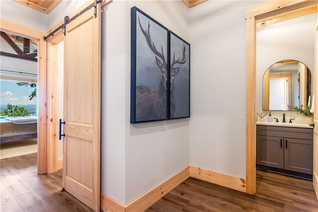1272 Foxhound Trail Northeast Ranger, GA 30734 - Photo 56 of 69 a view of a hallway with wooden floor and staircase