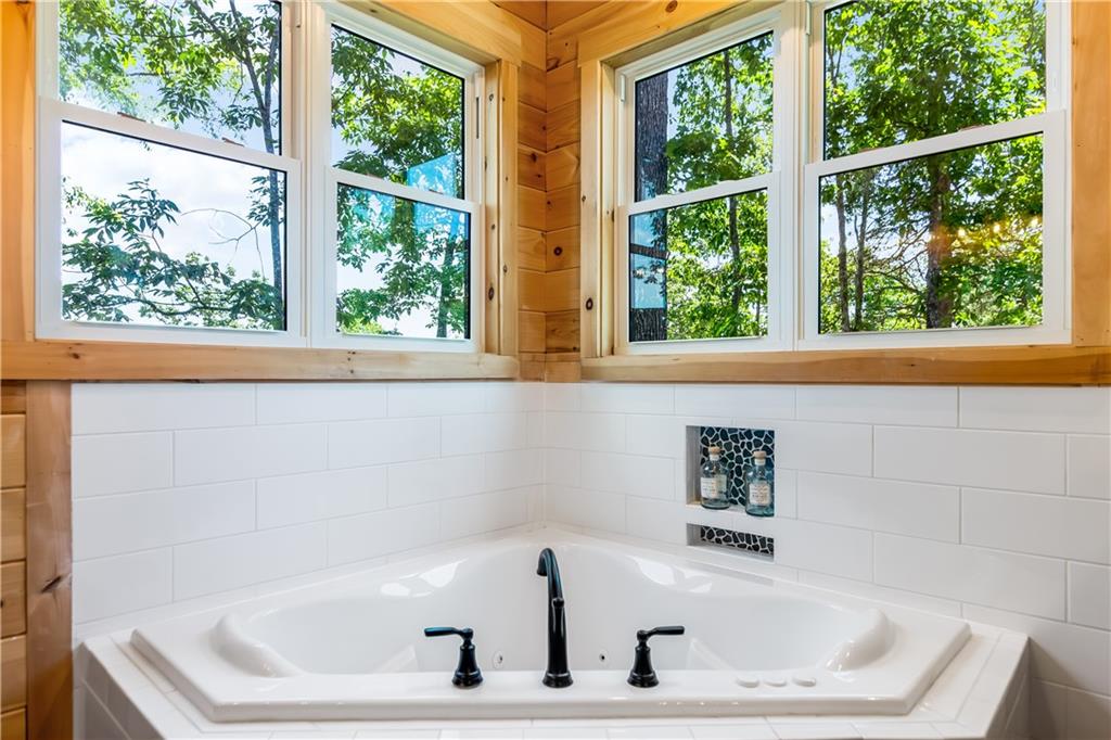 1272 Foxhound Trail Northeast Ranger, GA 30734 - Photo 62 of 69 a white bath tub sitting in front of a window