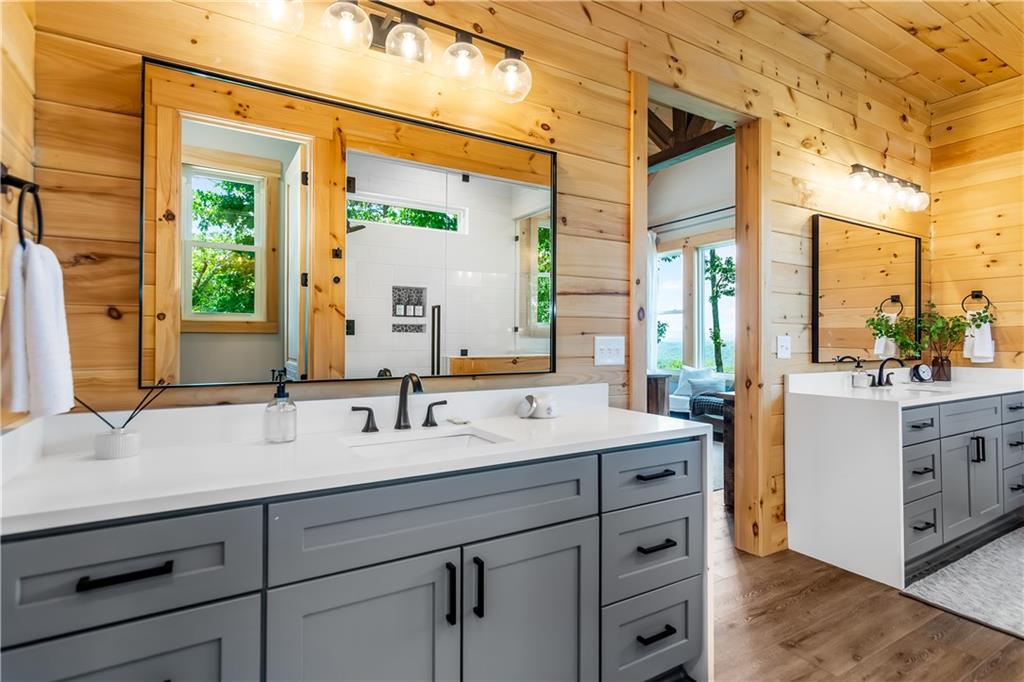 1272 Foxhound Trail Northeast Ranger, GA 30734 - Photo 63 of 69 a spacious bathroom with a double vanity sink a mirror and a shower
