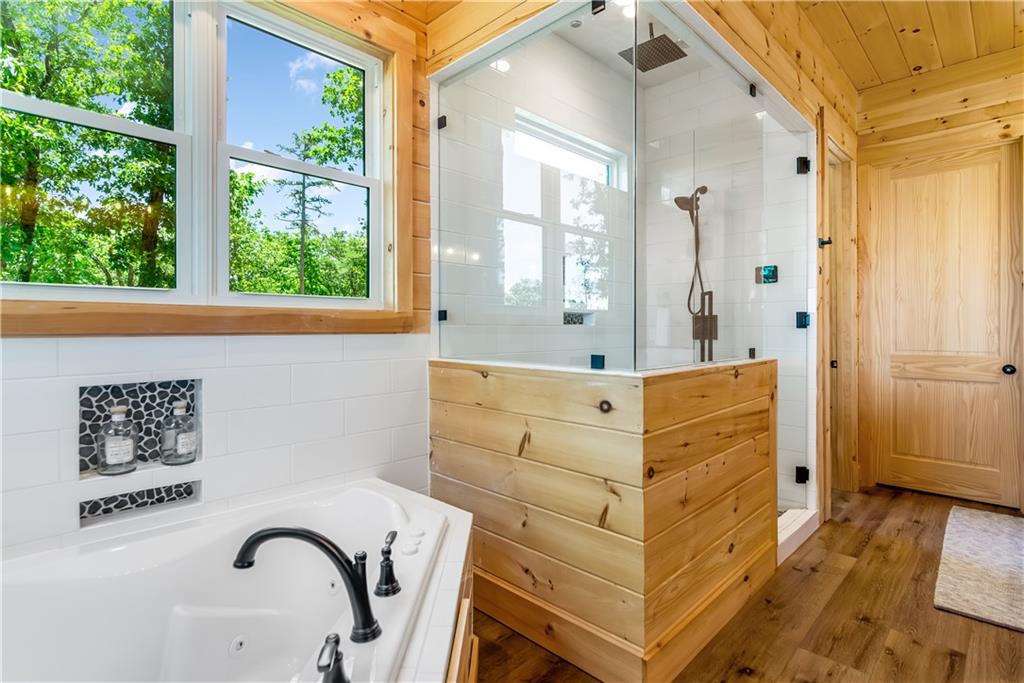 1272 Foxhound Trail Northeast Ranger, GA 30734 - Photo 65 of 69 a bathroom with a bathtub sink and mirror