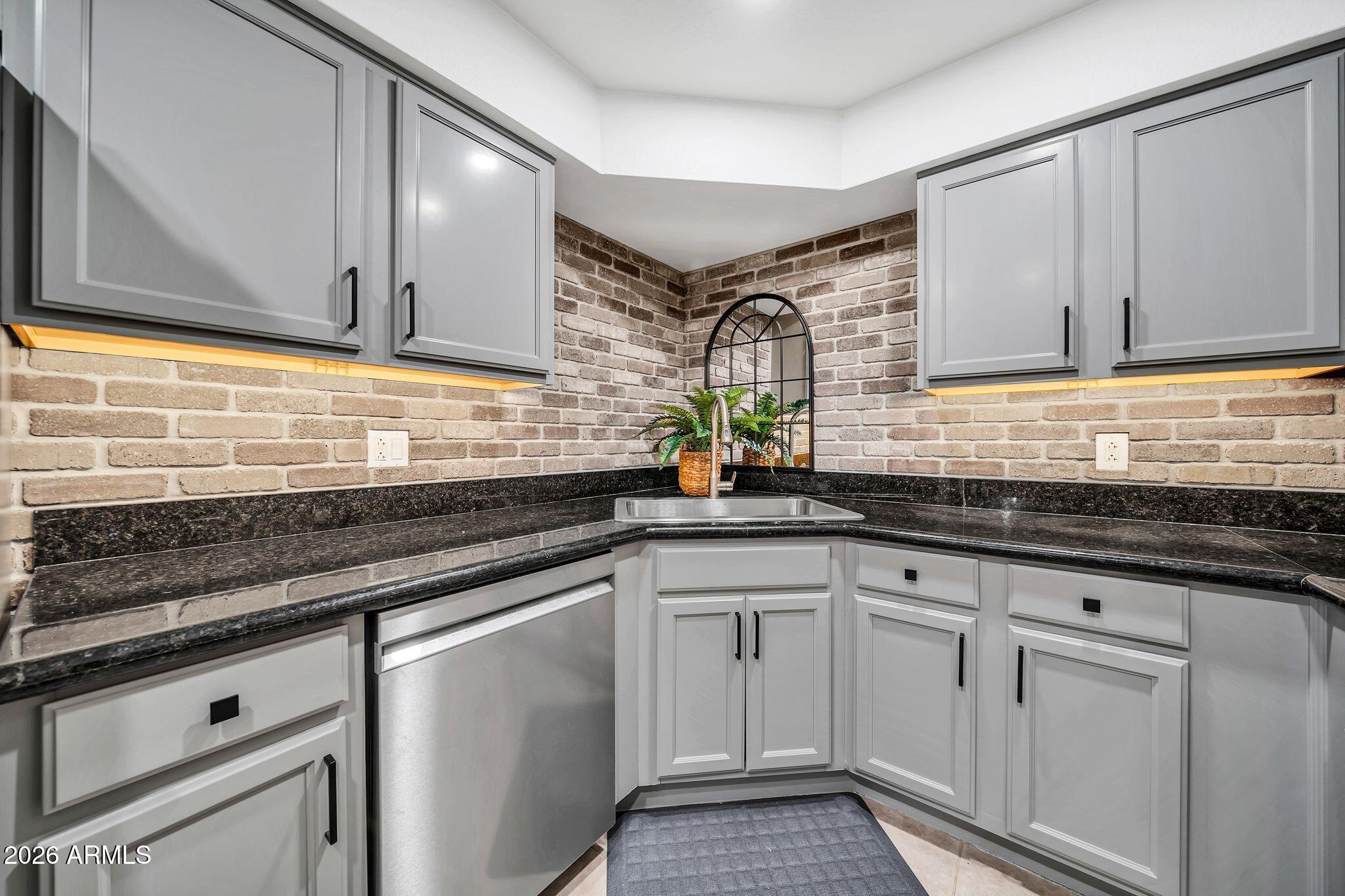 8787 East Mountain View Road, Unit 2038 Scottsdale, AZ 85258 - Photo 16 of 37 a kitchen with granite countertop white cabinets and white appliances