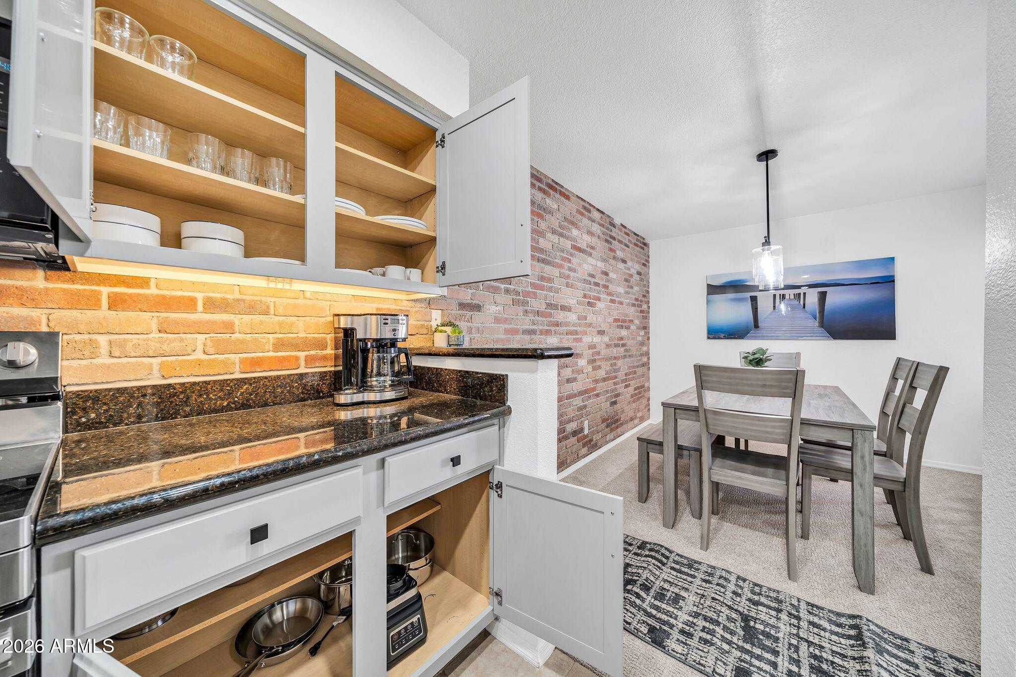 8787 East Mountain View Road, Unit 2038 Scottsdale, AZ 85258 - Photo 18 of 37 a kitchen with a stove and a table