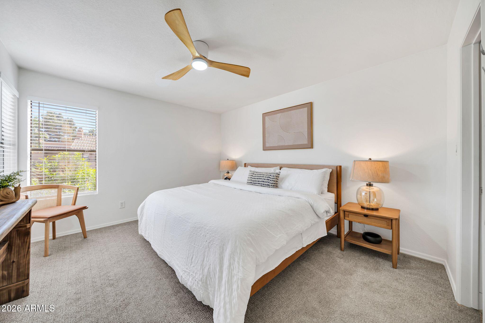 8787 East Mountain View Road, Unit 2038 Scottsdale, AZ 85258 - Photo 21 of 37 a bedroom with a bed a couch and a window