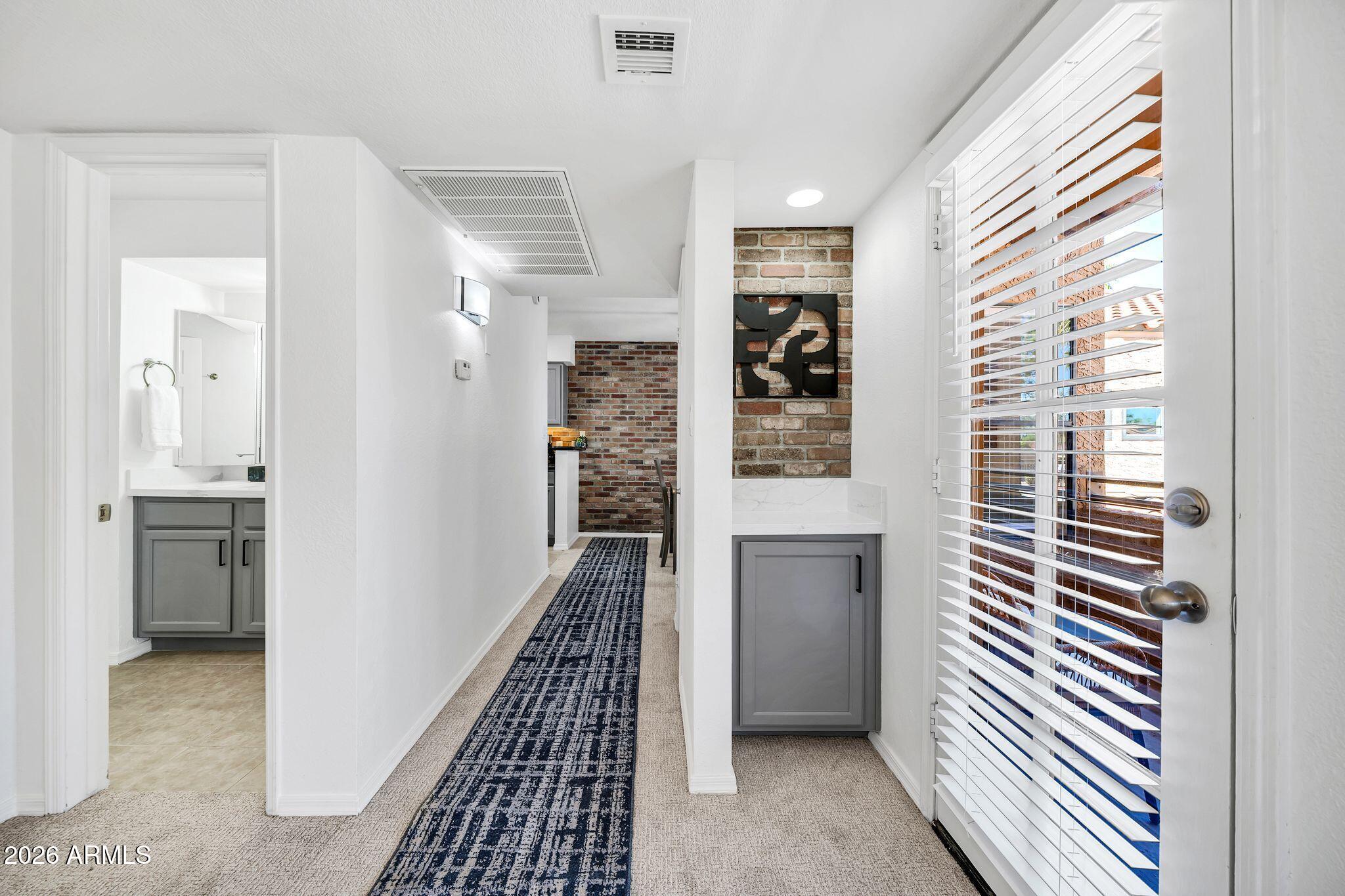 8787 East Mountain View Road, Unit 2038 Scottsdale, AZ 85258 - Photo 25 of 37 a view of a hallway with windows and entryway