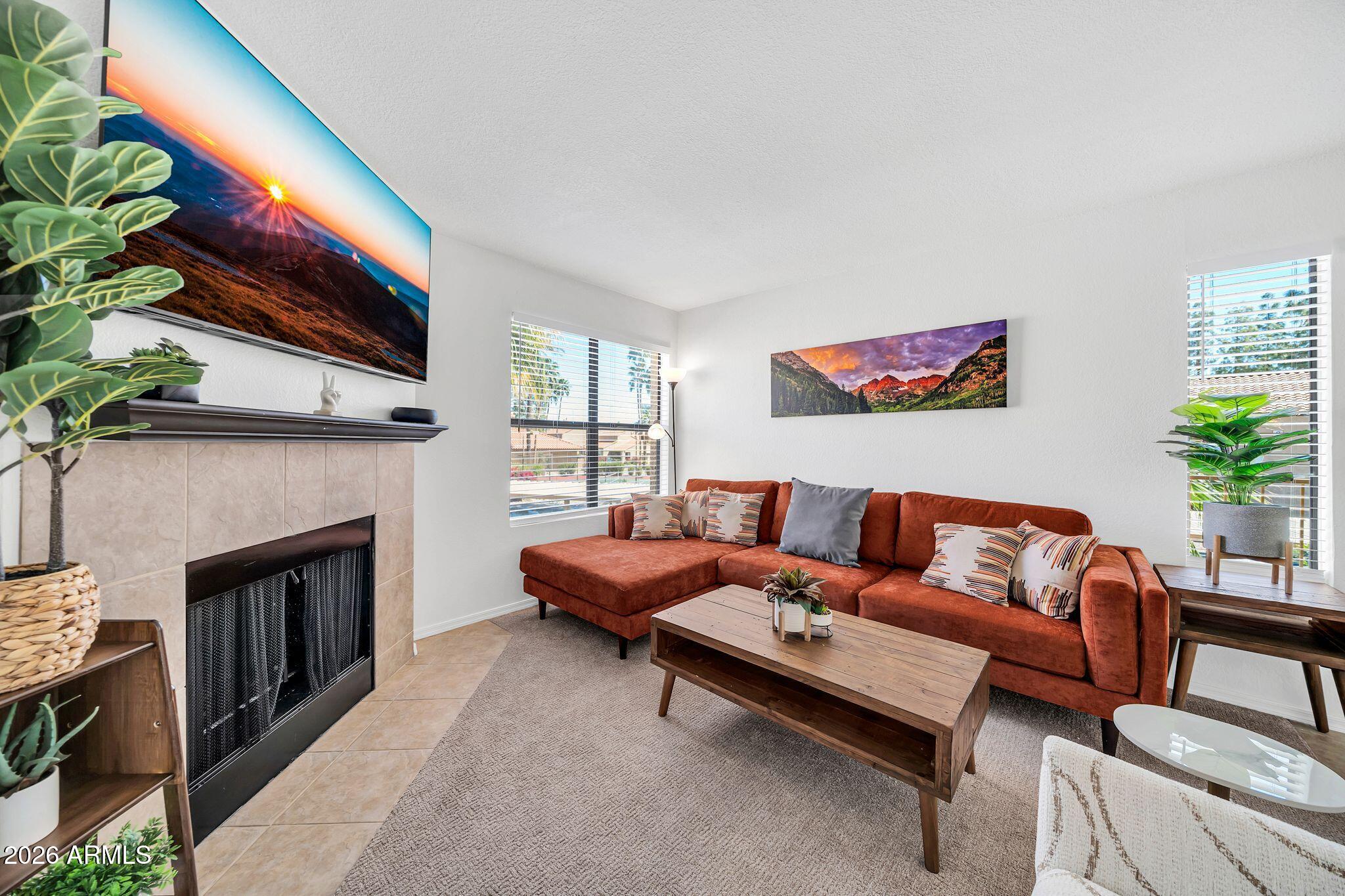 8787 East Mountain View Road, Unit 2038 Scottsdale, AZ 85258 - Photo 3 of 37 a living room with furniture and a fireplace