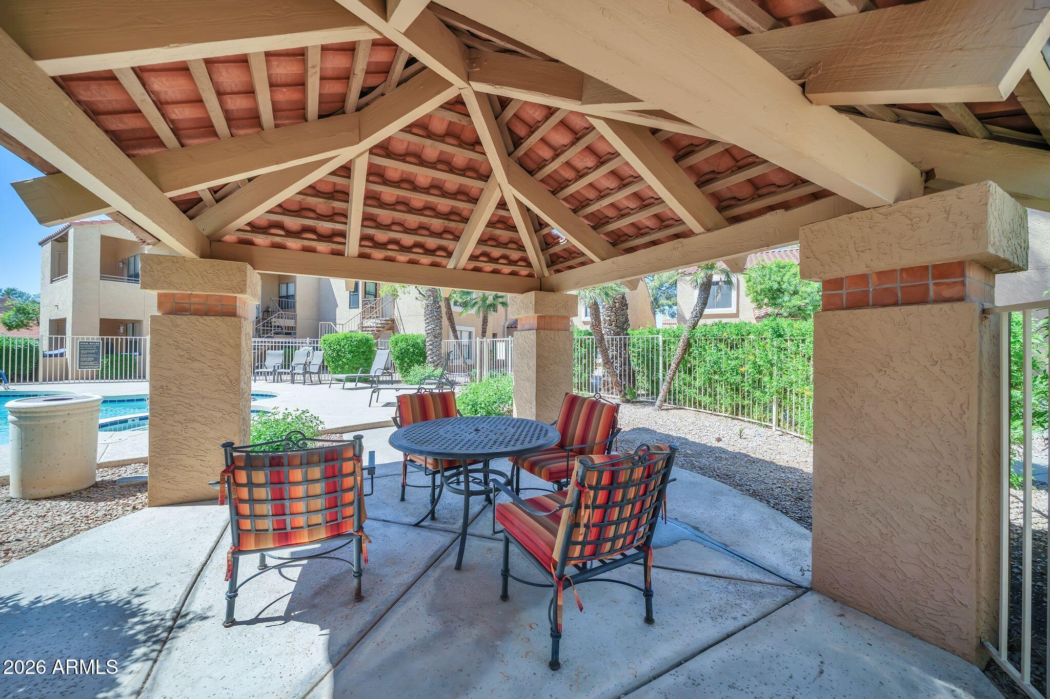 8787 East Mountain View Road, Unit 2038 Scottsdale, AZ 85258 - Photo 31 of 37 a view of a porch with furniture and a yard