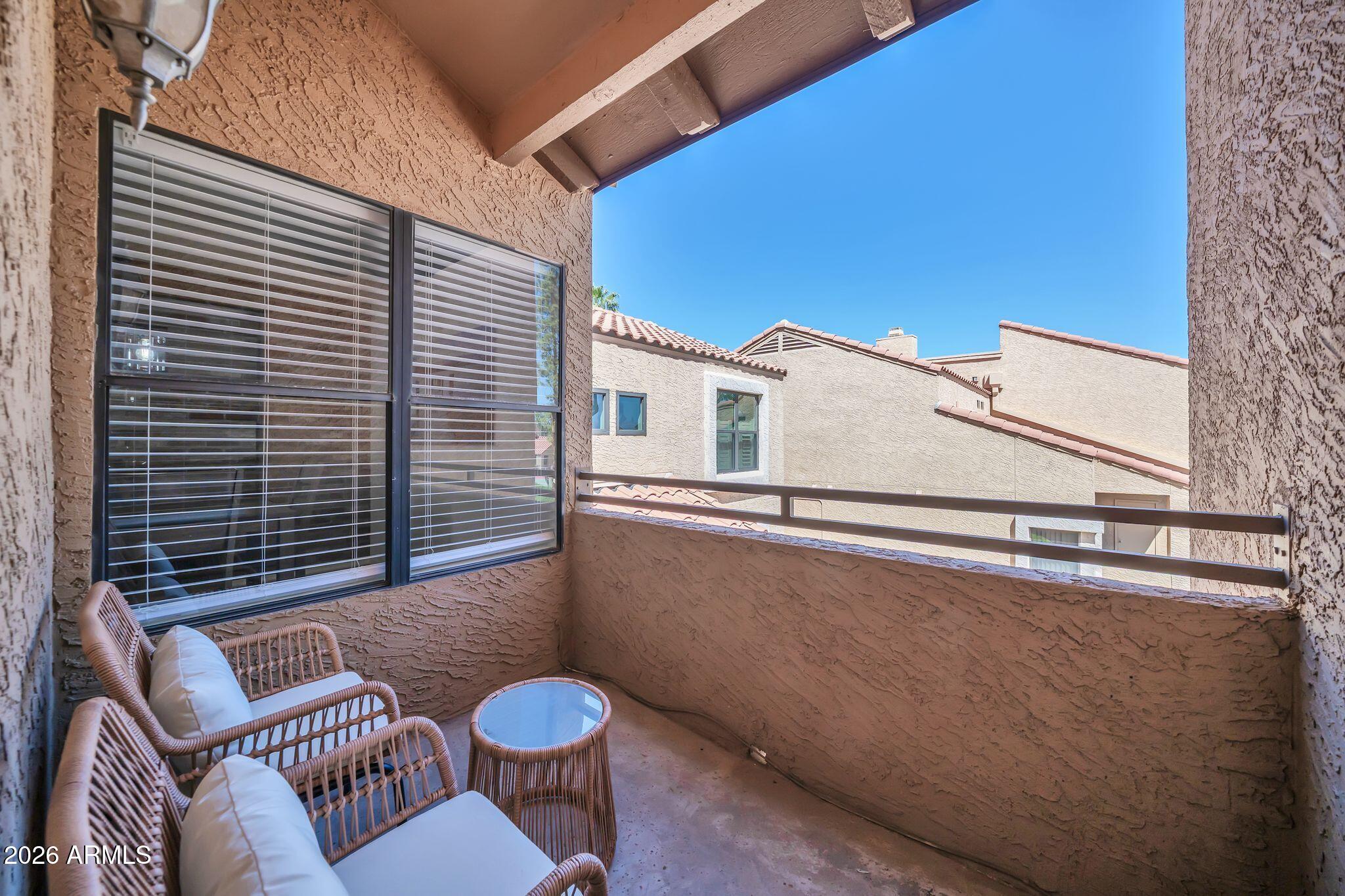 8787 East Mountain View Road, Unit 2038 Scottsdale, AZ 85258 - Photo 36 of 37 a view of a balcony with chairs and a potted plant