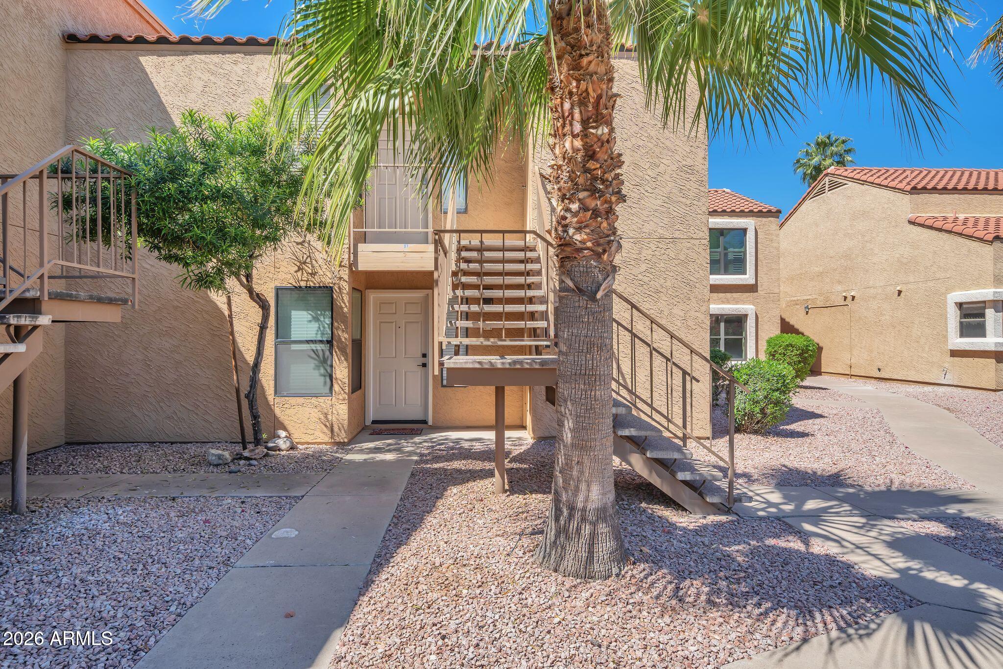 8787 East Mountain View Road, Unit 2038 Scottsdale, AZ 85258 - Photo 5 of 37 a view of a house with a yard
