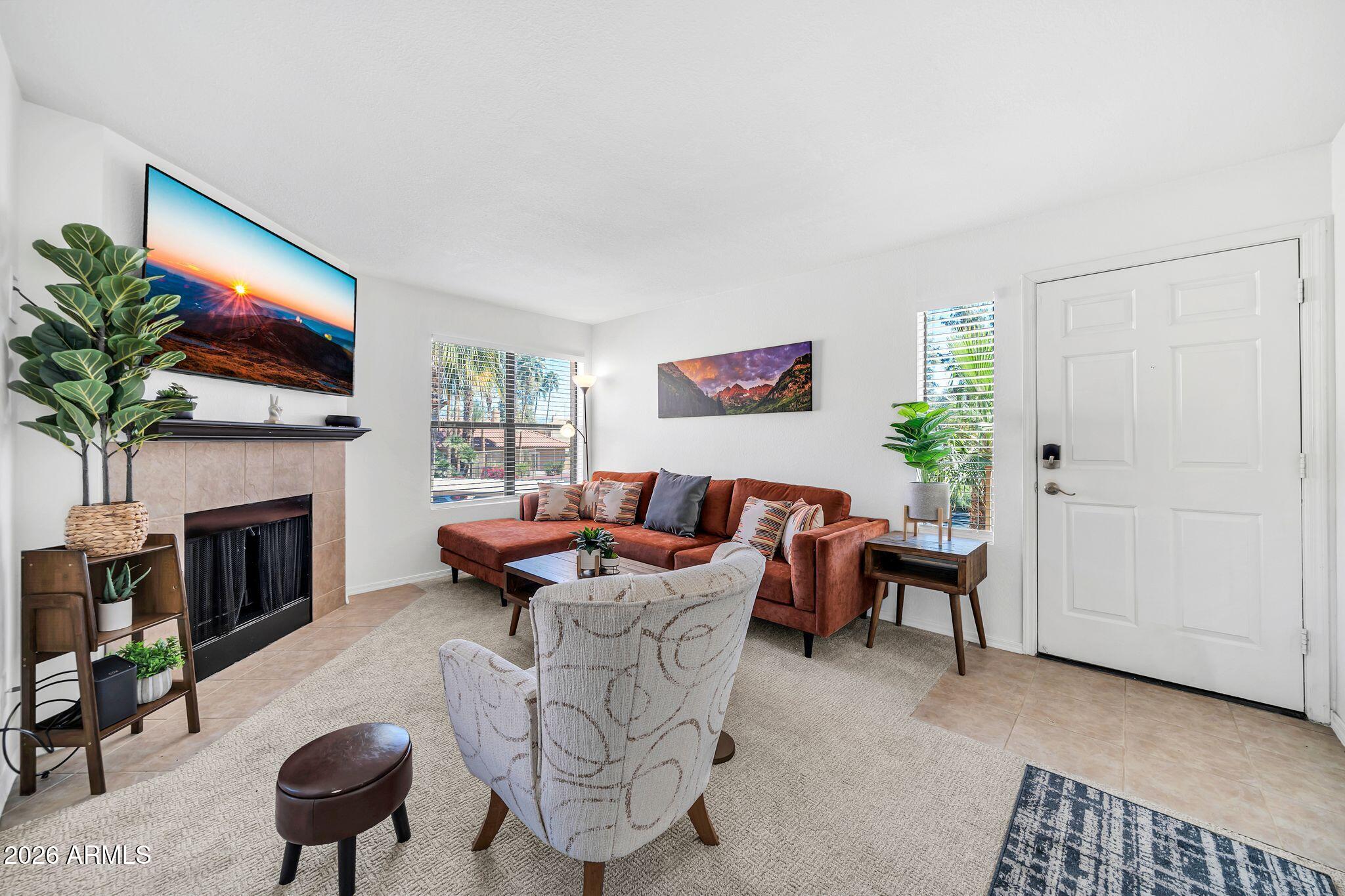 8787 East Mountain View Road, Unit 2038 Scottsdale, AZ 85258 - Photo 8 of 37 a living room with furniture a flat screen tv and a fireplace