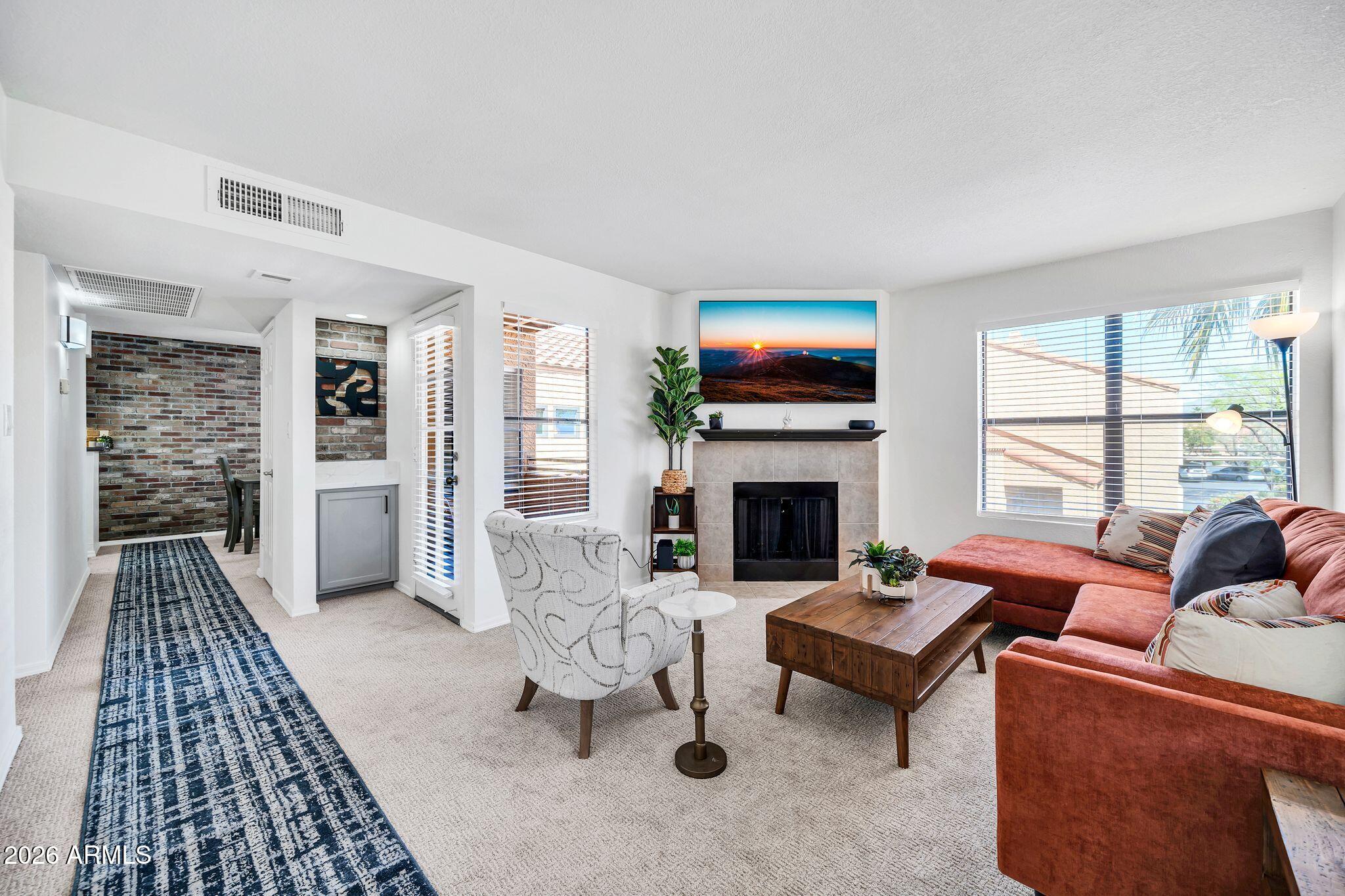 8787 East Mountain View Road, Unit 2038 Scottsdale, AZ 85258 - Photo 9 of 37 a living room with furniture fireplace and flat screen tv