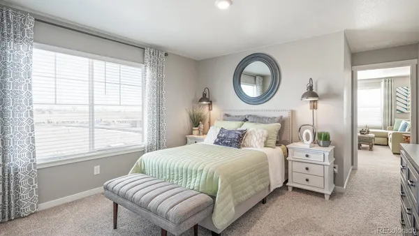 a bedroom with bed and a large mirror