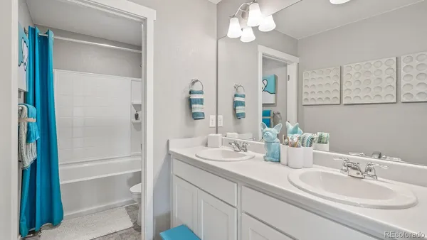 a bathroom with a double vanity sink mirror and double