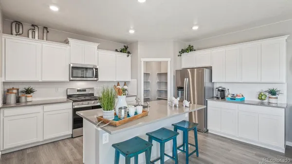 a kitchen with stainless steel appliances a white stove top oven and a refrigerator