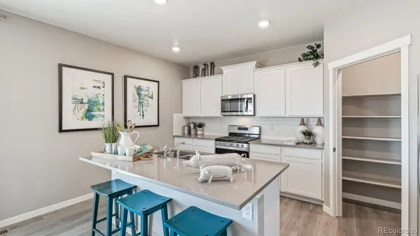 a kitchen with a sink stove and microwave