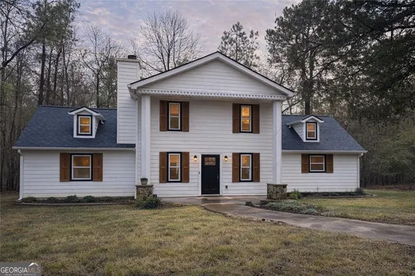 a front view of a house with a yard